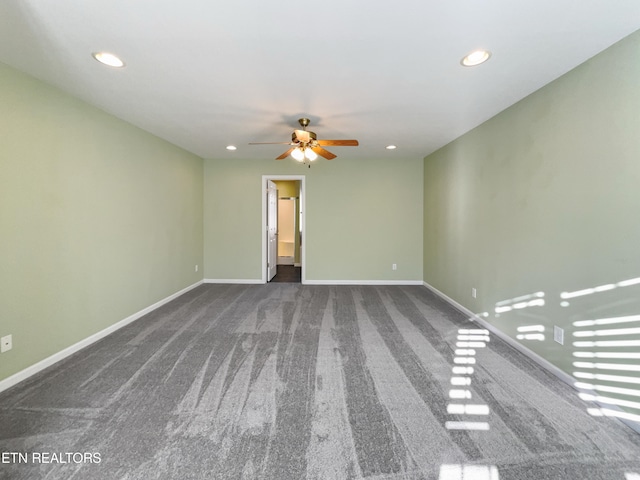 carpeted spare room with ceiling fan