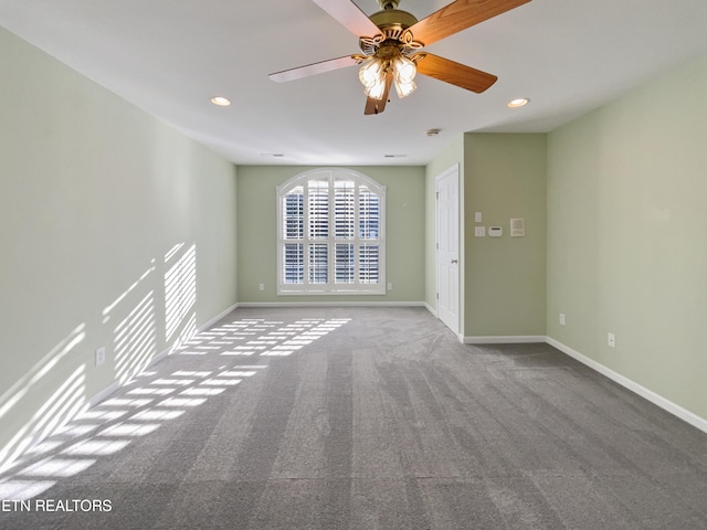 carpeted spare room with ceiling fan