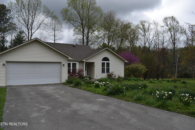 single story home with a garage, aphalt driveway, and a shingled roof