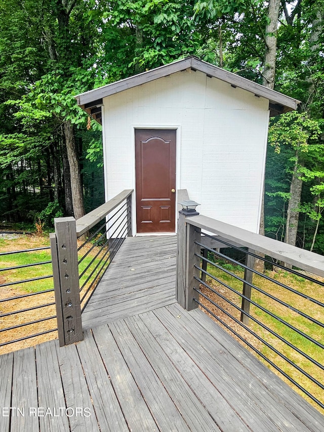 wooden terrace featuring a shed