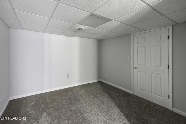 basement with carpet flooring and a drop ceiling