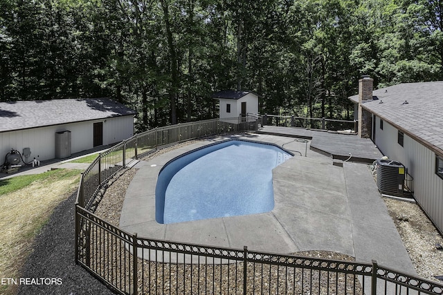 view of pool with an outbuilding and cooling unit