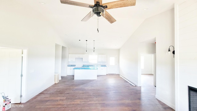 interior space with high vaulted ceiling, ceiling fan, and light hardwood / wood-style flooring