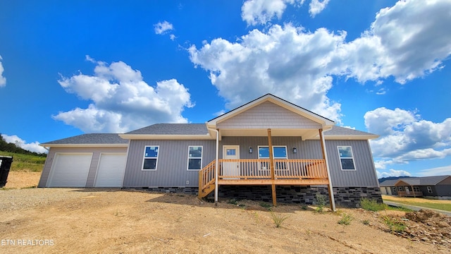 view of front of home featuring covered porch and a garage