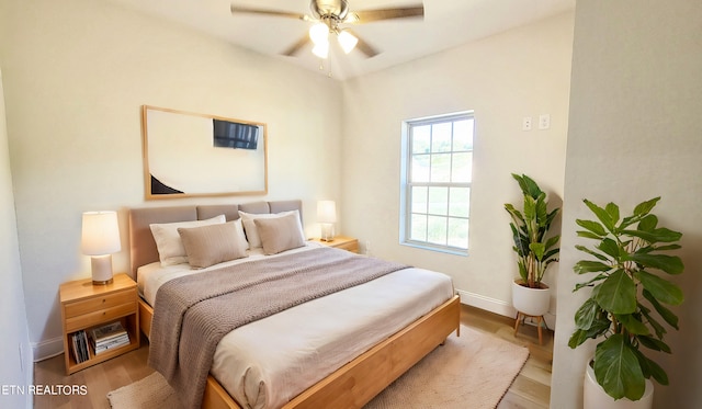 bedroom with ceiling fan and light hardwood / wood-style flooring