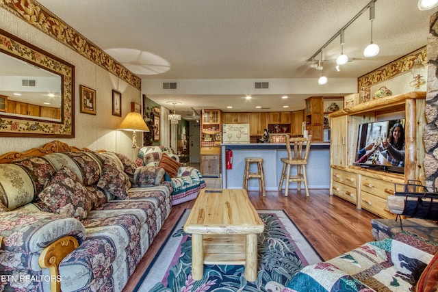 1081 Cove Rd Unit 1012, Sevierville, TN 37876 - living area featuring wallpapered walls, a textured ceiling, and wood finished floors