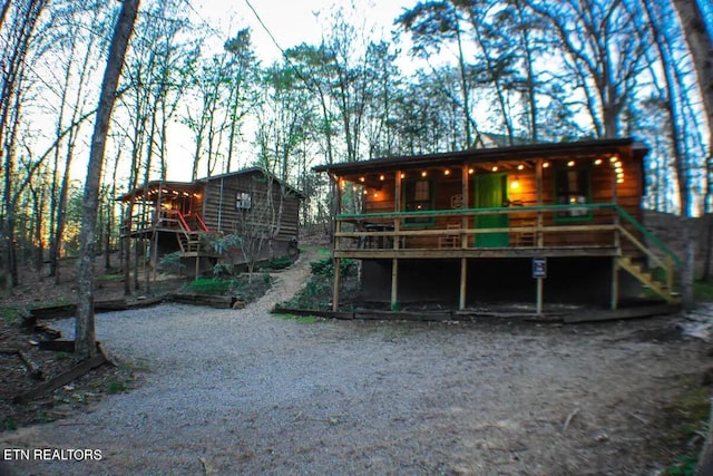 rear view of house featuring a wooden deck