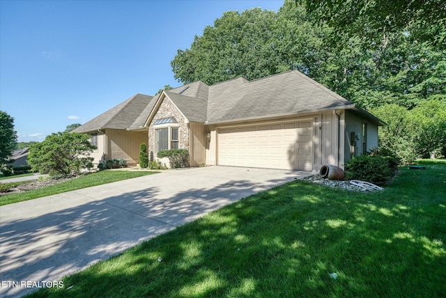 view of front of house with a front yard and a garage