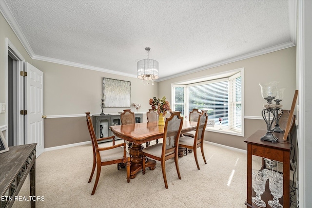 dining area featuring ornamental molding, light colored carpet, a textured ceiling, and an inviting chandelier