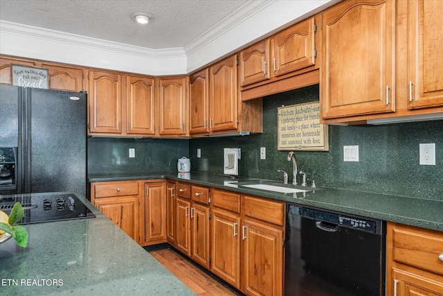 kitchen with black appliances, a textured ceiling, sink, and tasteful backsplash