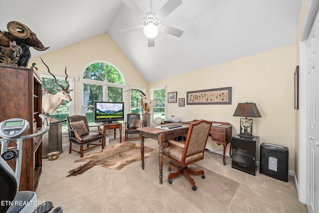 carpeted office space with vaulted ceiling and ceiling fan