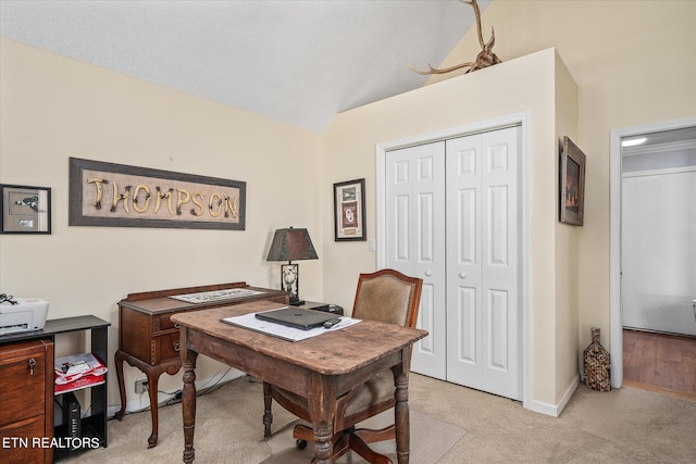 office area with light colored carpet and lofted ceiling