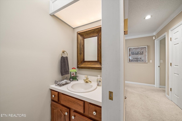 bathroom featuring a textured ceiling, vanity, and crown molding