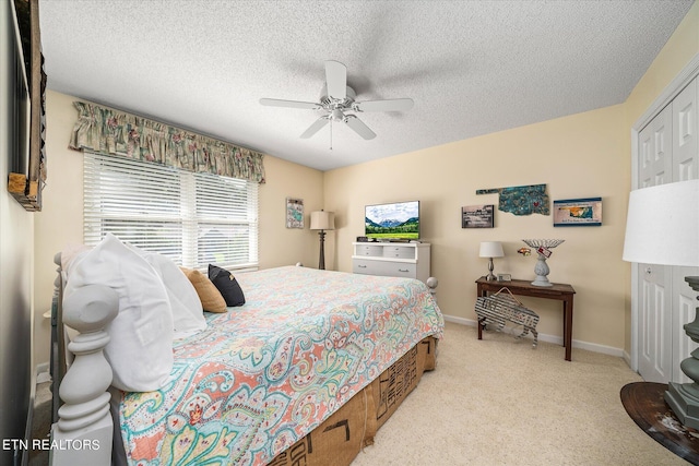 bedroom with a textured ceiling, a closet, and ceiling fan