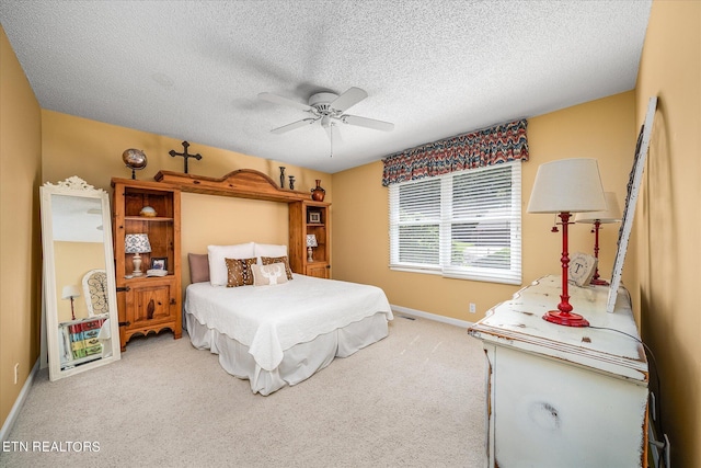 carpeted bedroom featuring a textured ceiling and ceiling fan