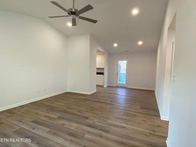 unfurnished living room featuring ceiling fan, hardwood / wood-style floors, and vaulted ceiling