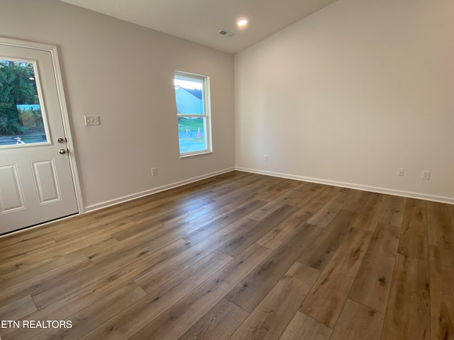 unfurnished room featuring light hardwood / wood-style flooring and plenty of natural light