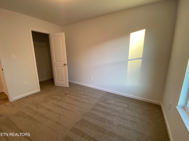 unfurnished bedroom with a closet and carpet