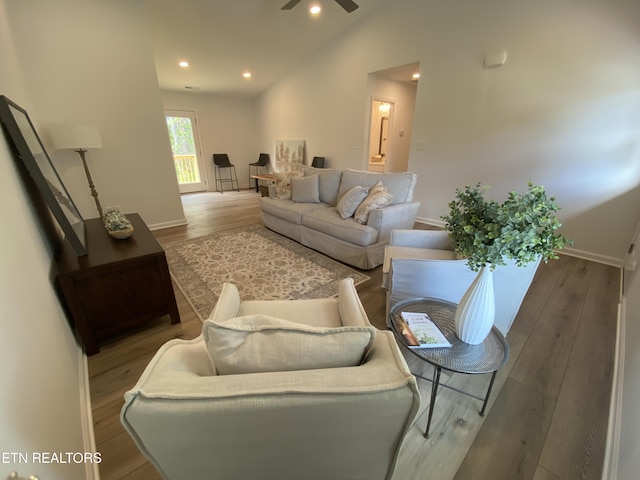 living room featuring baseboards, recessed lighting, vaulted ceiling, wood finished floors, and a ceiling fan