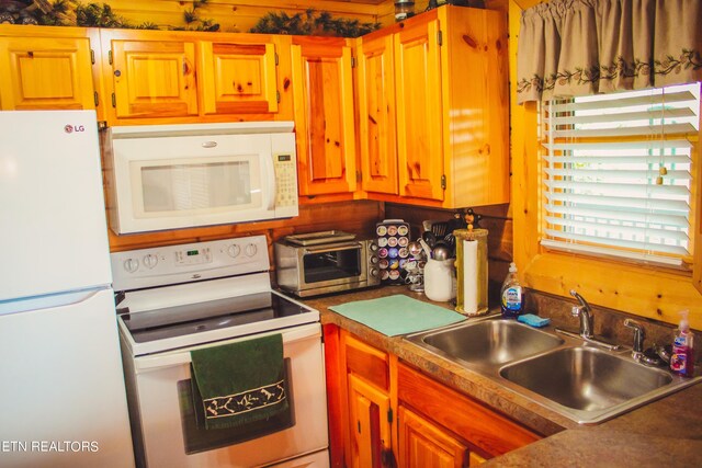 kitchen featuring sink and white appliances