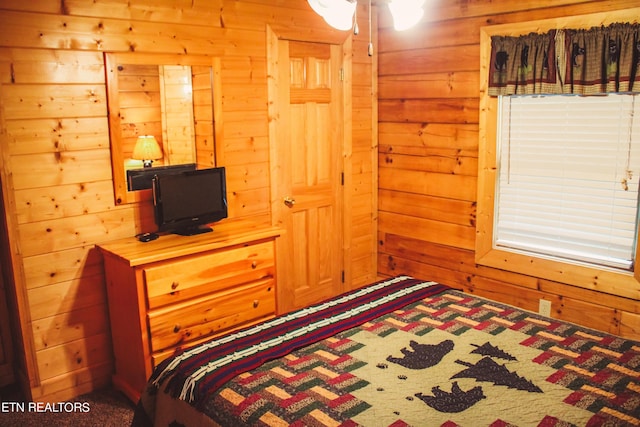bedroom featuring wooden walls
