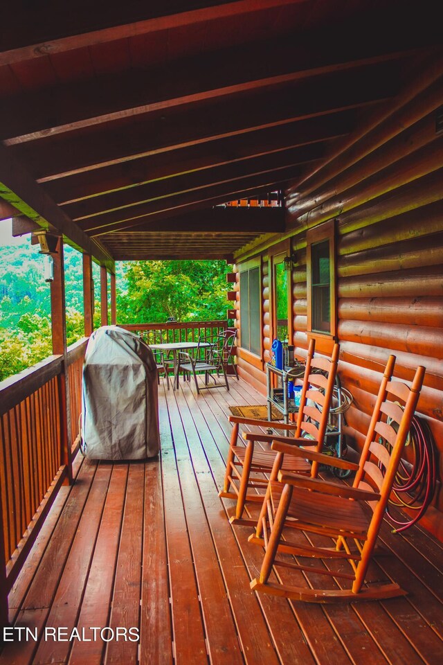 wooden terrace with a grill