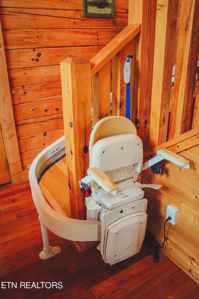 bathroom with wooden walls and hardwood / wood-style flooring
