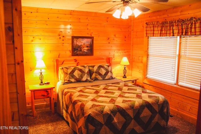 carpeted bedroom featuring ceiling fan and multiple windows