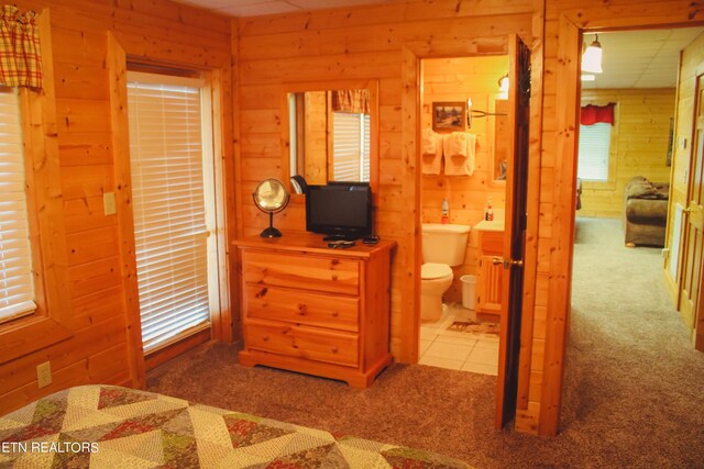 carpeted bedroom featuring connected bathroom