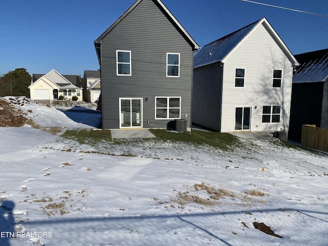 snow covered house with cooling unit