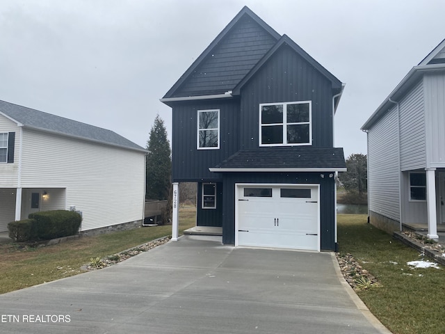 view of front of home with a front lawn and a garage