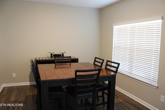 dining area with dark hardwood / wood-style flooring