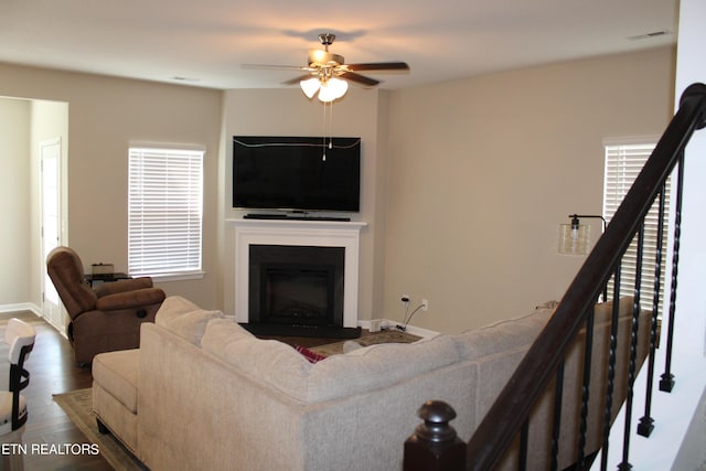 living room featuring ceiling fan, wood-type flooring, and plenty of natural light