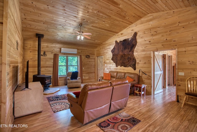 living room with wooden walls, a wood stove, light hardwood / wood-style flooring, a wall unit AC, and wood ceiling