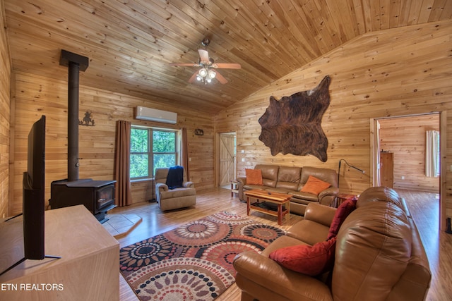 living room with vaulted ceiling, a wood stove, an AC wall unit, light wood-type flooring, and wood ceiling