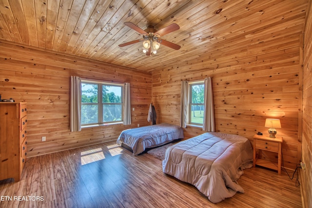 bedroom featuring light wood-type flooring, ceiling fan, wooden ceiling, and multiple windows