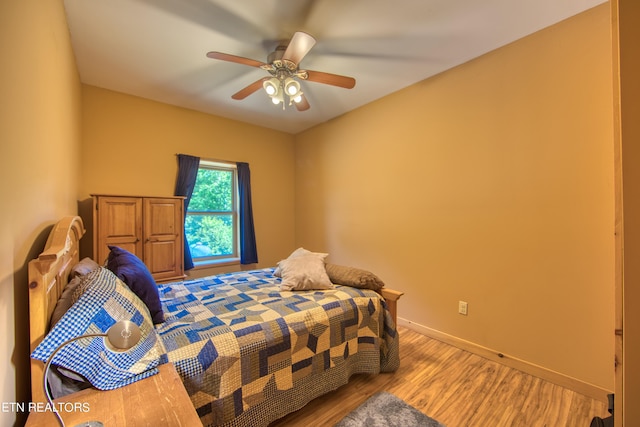 bedroom featuring ceiling fan and hardwood / wood-style floors