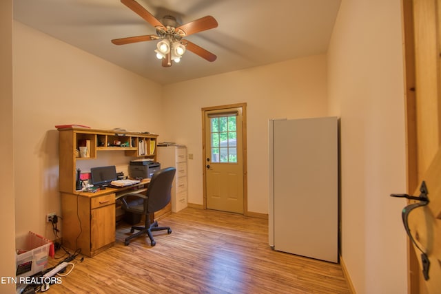 home office with ceiling fan and light hardwood / wood-style floors