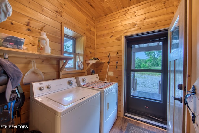 laundry room featuring separate washer and dryer, wood ceiling, wooden walls, and dark wood-type flooring