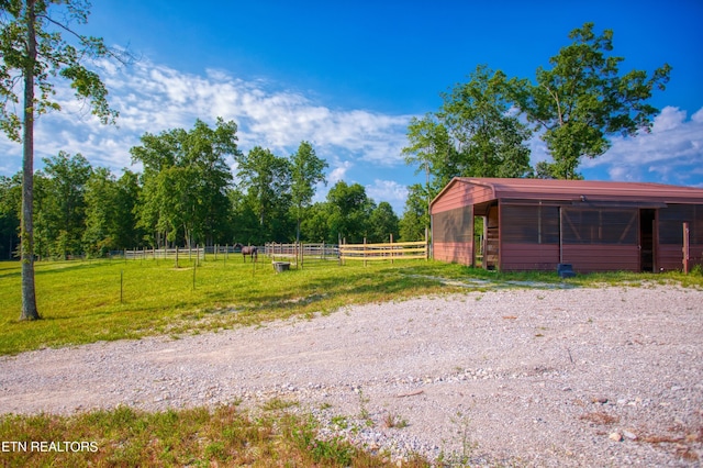 view of yard with a rural view and an outbuilding