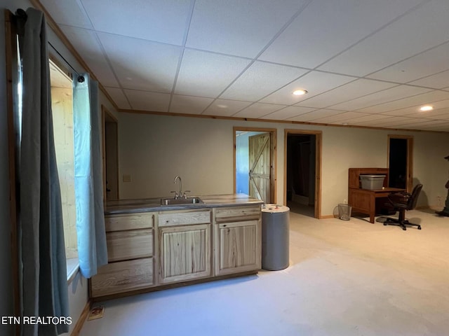 bar with a drop ceiling, light brown cabinets, and sink