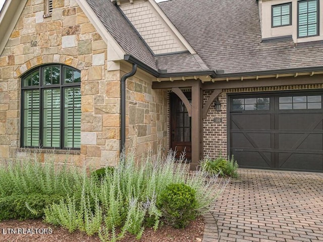 doorway to property with a garage