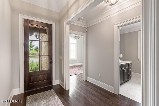 entryway with dark hardwood / wood-style floors and ornamental molding