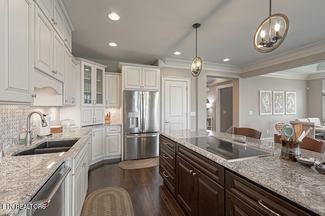 kitchen with light stone countertops, sink, white cabinetry, and stainless steel appliances