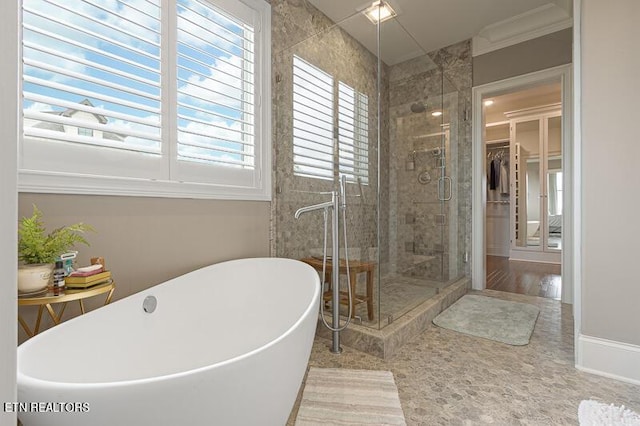 bathroom with independent shower and bath and crown molding