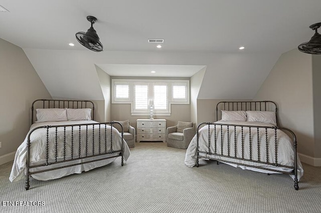 bedroom with vaulted ceiling and light carpet