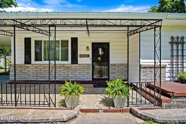 view of exterior entry with a porch