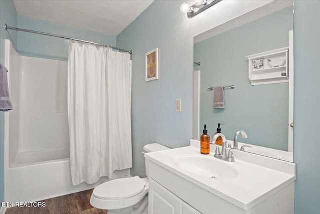 full bathroom featuring toilet, wood-type flooring, vanity, and shower / bath combo with shower curtain