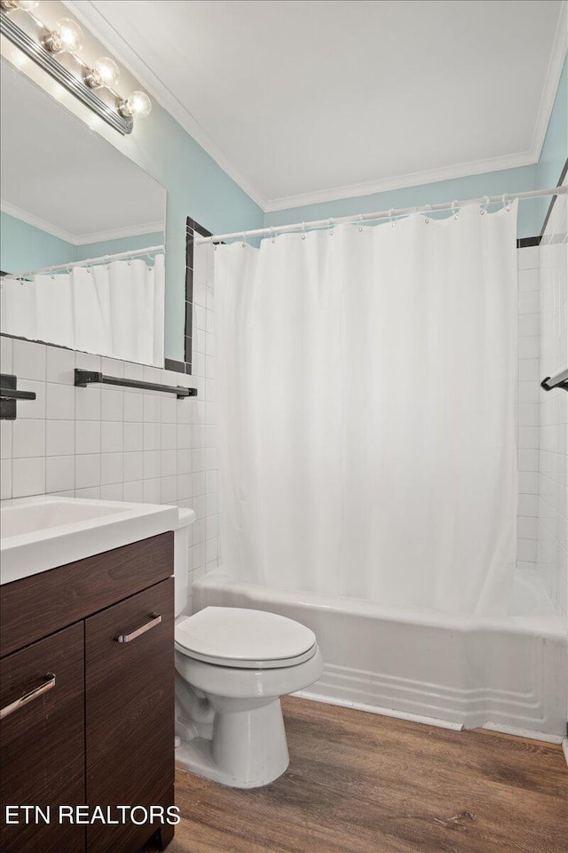 full bathroom featuring toilet, ornamental molding, hardwood / wood-style flooring, and vanity