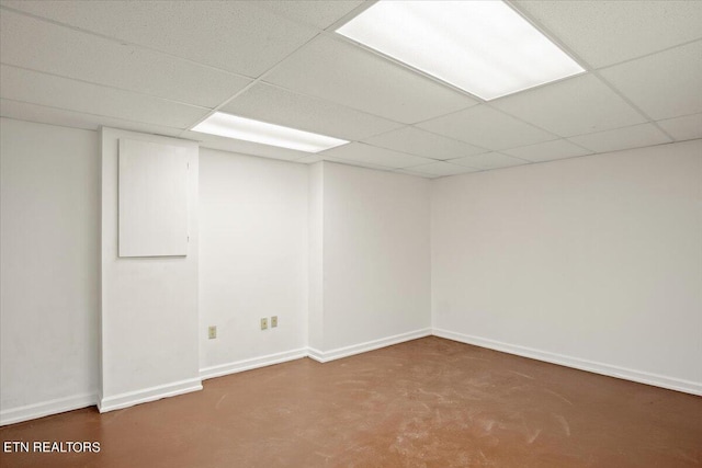 carpeted spare room featuring a paneled ceiling